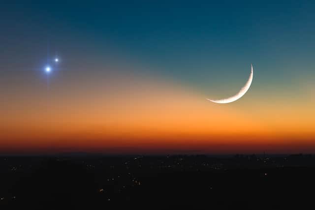 Astronomical conjunction of Saturn, Jupiter and Moon. (Shutterstock)