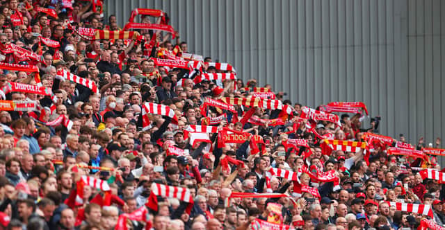 Liverpool fans hold their scarves aloft at Anfield. Photo by Catherine Ivill/Getty Images