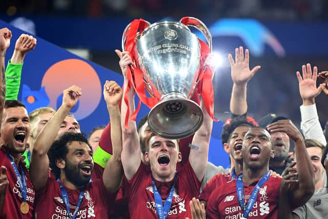 Andy Robertson lift the Champions League trophy aloft following Liverpool’s triumph over Tottenham in 2019. Picture: Michael Regan/Getty Images
