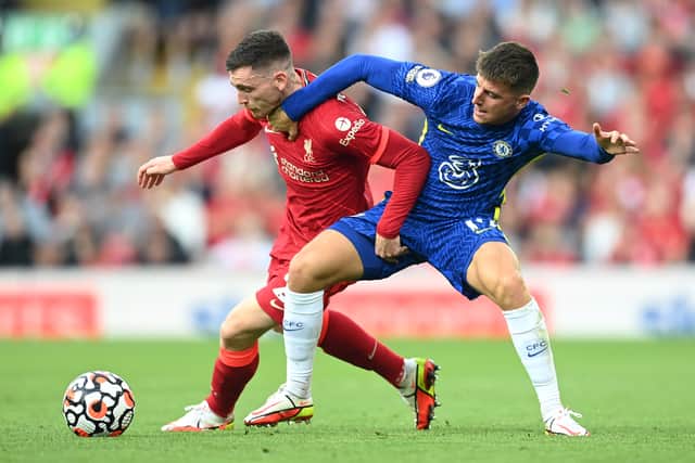 LIVERPOOL, ENGLAND - AUGUST 28: Andrew Robertson of Liverpool battles for possession with Mason Mount of Chelsea  during the Premier League match between Liverpool  and  Chelsea at Anfield on August 28, 2021 in Liverpool, England. (Photo by Michael Regan/Getty Images)