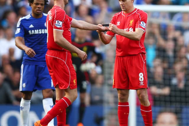LONDON, ENGLAND - MAY 10:  Steven Gerrard of Liverpool hands the captain’s armband to Jordan Henderson of Liverpool as he is substiytuted in the second half during the Barclays Premier League match between Chelsea and Liverpool at Stamford Bridge on May 10, 2015 in London, England.  (Photo by Clive Rose/Getty Images)