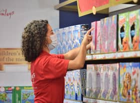 A retail assistant stocks the shelves at a Hamleys store. Photo: JUSTIN TALLIS/AFP via Getty Images