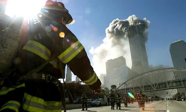 Firefighters walk towards one of the towers at the World Trade Center before it collapsed. Photo: Jose Jimenez/Primera Hora/Getty Images