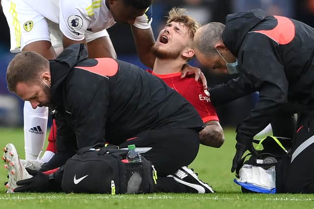 LEEDS, ENGLAND - SEPTEMBER 12: Harvey Elliott of Liverpool receives medical treatment during the Premier League match between Leeds United and Liverpool at Elland Road on September 12, 2021 in Leeds, England. (Photo by Laurence Griffiths/Getty Images)