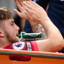 Harvey Elliott of Liverpool applauds the fans as he leaves the pitch on a stretcher. Photo: Laurence Griffiths/Getty Images