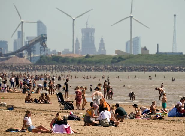 <p>People enjoy the warm weather on Crosby Beach last year. (Photo: Christopher Furlong/Getty Images)</p>