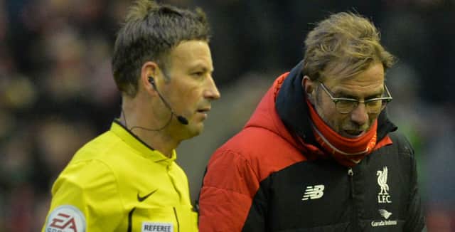 Liverpool boss Jurgen Klopp talks to referee Mark Clattenburg. Picture:  PAUL ELLIS/AFP via Getty Images