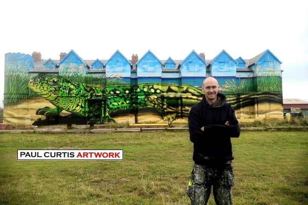 Artist Paul Curtis with the giant mural on the side of Toad Hall, Ainsdale. Image: Paul Curtis 