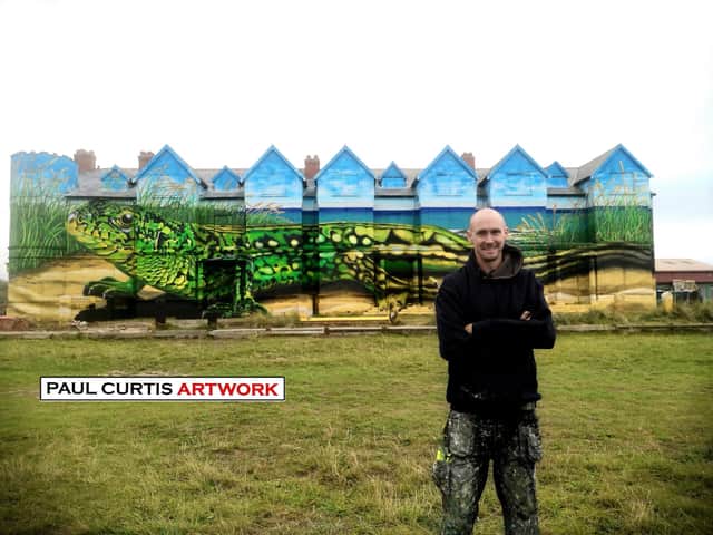 Artist Paul Curtis with the giant mural on the side of Toad Hall, Ainsdale. Image: Paul Curtis 