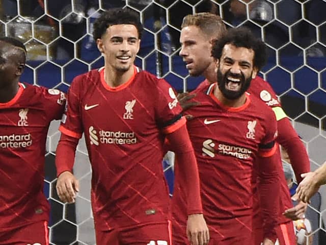 Liverpool celebrate scoring in their 5-1 Champions League win over Porto while wearing their 2021-22 season home kit. Picture: MIGUEL RIOPA / AFP) (Photo by MIGUEL RIOPA/AFP via Getty Images