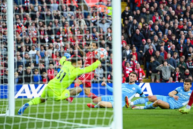 LIVERPOOL, ENGLAND - OCTOBER 03: Mohamed Salah of Liverpool scores to make it 2-1 during the Premier League match between Liverpool and Manchester City at Anfield on October 03, 2021 in Liverpool, England. (Photo by Michael Regan/Getty Images)