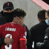 Roberto Firmino is embraced by Jurgen Klopp after coming off in Liverpool’s defeat of Atletico Madrid injured. Picture: OLI SCARFF/AFP via Getty Images