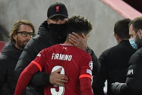 Roberto Firmino is embraced by Jurgen Klopp after coming off in Liverpool’s defeat of Atletico Madrid injured. Picture: OLI SCARFF/AFP via Getty Images
