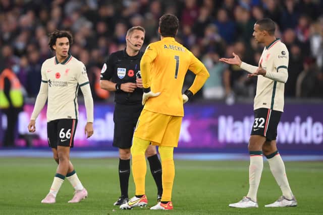 Alisson and Joel Matip speak to referee Craig Pawson. Picture: Mike Hewitt/Getty Images