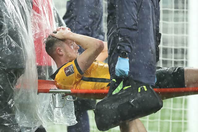 Harry Souttar is stretchered off during Australia’s clash with Saudi Arabia. Picture: Mark Metcalfe/Getty Images