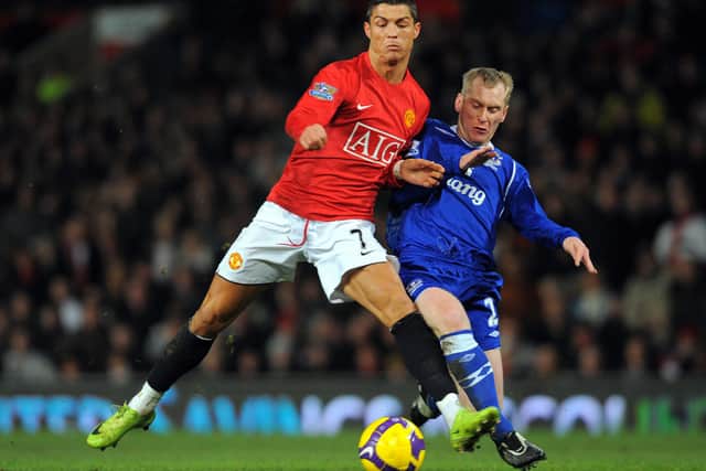 Tony Hibbert battles Cristiano Ronaldo for the ball during Everton’s clash with Man Utd in 2009. Picture: ANDREW YATES/AFP via Getty Images