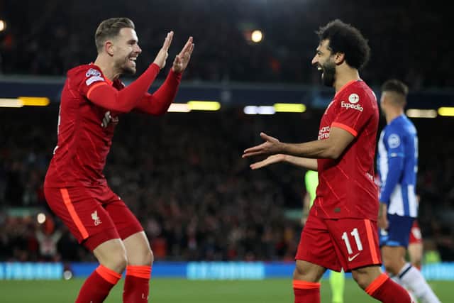 Mo Salah, right, celebrates scoring Liverpool’s second goal against Porto with Jordan Henderson. Picture: Clive Brunskill/Getty Images