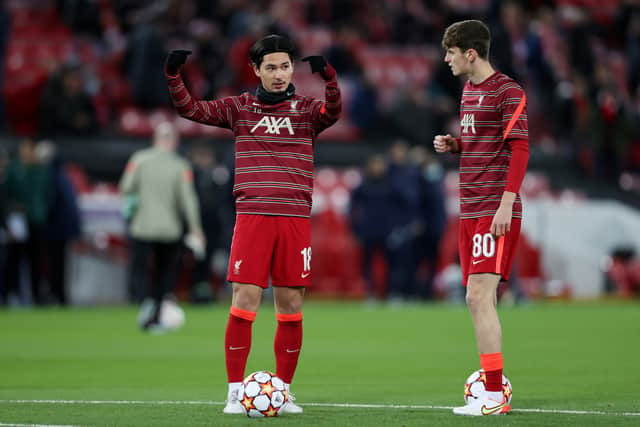 Tyler Morton, right, speaks to Takumi Minamino ahead of Liverpool’s clash with Porto. Picture: Clive Brunskill/Getty Images