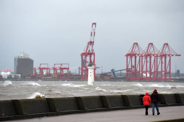 People out walking near the River Mersey during Storm Ciara in 2020.