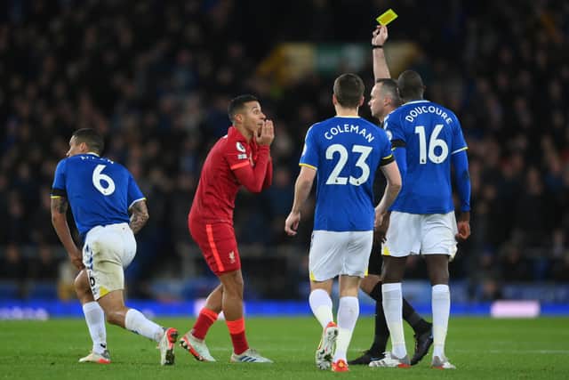 Thiago Alcantara of Liverpool is shown a yellow card by referee, Paul Tierney during the Premier League match between Everton and Liverpool at Goodison Park on December 01, 2021 in Liverpool, England. (Photo by Laurence Griffiths/Getty Images)
