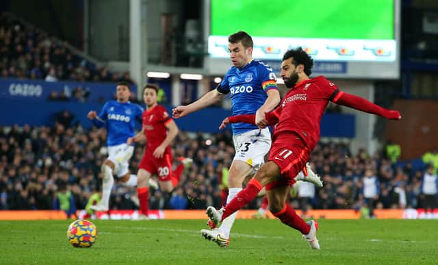 Mohamed Salah of Liverpool scores their side's third goal whilst under pressure from Seamus Coleman of Everton during the Premier League match between Everton and Liverpool at Goodison Park on December 01, 2021 in Liverpool, England. (Photo by Alex Livesey/Getty Images)