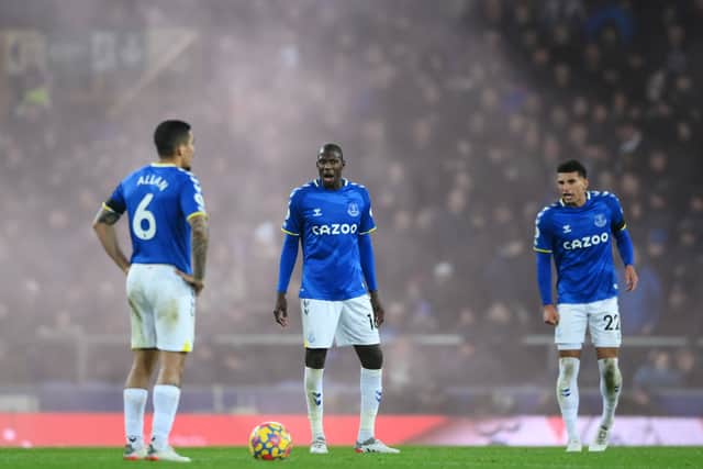  Doucoure of Everton looks dejected with teammates Allan and Ben Godfrey after the Liverpool fourth goal scored by Diogo Jota (Not pictured) during the Premier League match between Everton and Liverpool at Goodison Park on December 01, 2021 in Liverpool, England. (Photo by Laurence Griffiths/Getty Images