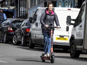 People ride e-scooters across Bristol City Centre