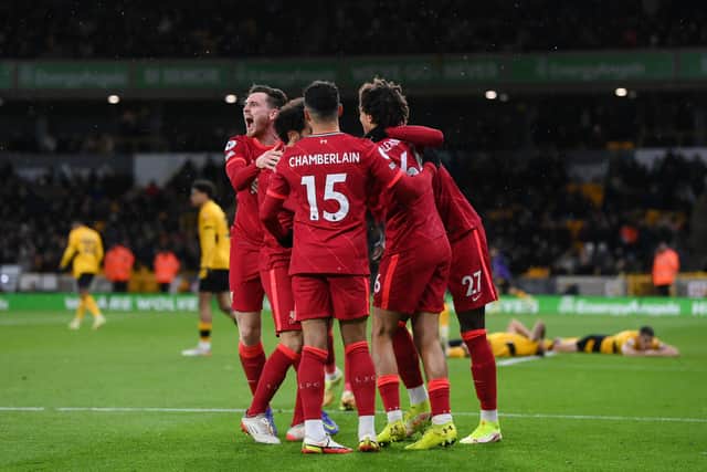 Divock Origi of Liverpool (obscured) celebrates with Alex Oxlade-Chamberlain, Andrew Robertson, Trent Alexander-Arnold and Mohamed Salah after scoring their side’s winning goal. Photo: Laurence Griffiths/Getty Images