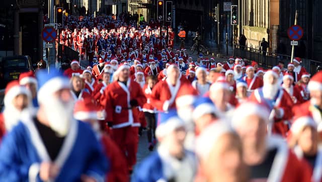Runners dressed in Father Christmas costumes take part in the annual 5k Santa Dash in Liverpool. Photo: PAUL ELLIS/AFP via Getty Images