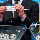 Liverpool are pulled out of the bowl during a previous Champions League draw. Photo: FABRICE COFFRINI/AFP via Getty Images