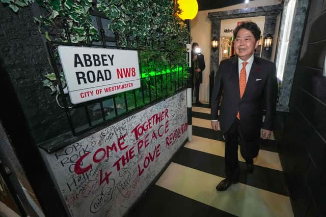 Japan's Foreign Minister Yoshimasa Hayashi walks across an Abbey Road display during a visit to The Beatles Story Museum