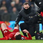 Andy Robertson was on the receiving end of a high challenge from Harry Kane. Picture: Julian Finney/Getty Images