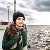 A woman wraps up warm on the Liverpool waterfront. Shutterstock