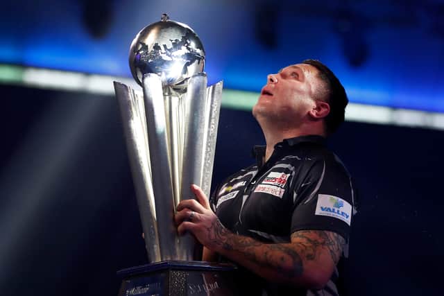 Gerwyn Price of Wales poses with the trophy during the Finals against Gary Anderson of Scotland during Day Sixteen of The PDC William Hill World Darts Championship at Alexandra Palace on January 03, 2021