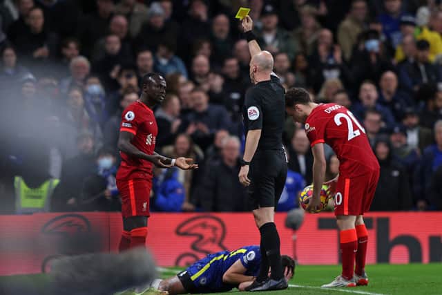 Anthony Taylor shows Liverpool forward Sadio Mane a yellow card. Picture: ADRIAN DENNIS/AFP via Getty Images)