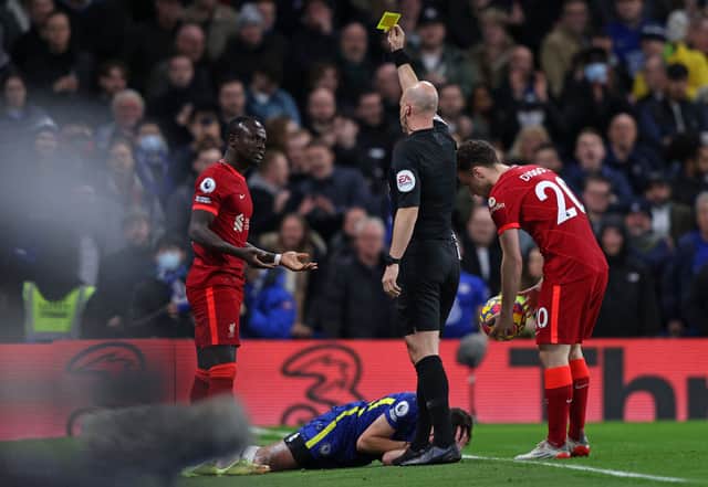 Anthony Taylor shows Liverpool forward Sadio Mane a yellow card. Picture: ADRIAN DENNIS/AFP via Getty Images)