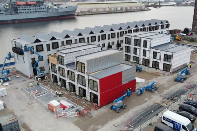 The red metal cladding goes on to a Row House at Wirral Waters