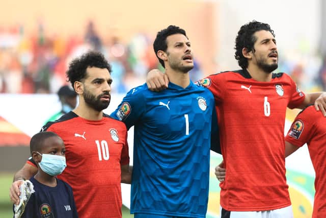 Egypt's forward Mohamed Salah (L), Egypt's goalkeeper Mohamed El Shenawy (C) and Egypt's defender Ahmed Hegazi (R) line up prior to the Group D Africa Cup of Nations (CAN) 2021 football match between Nigeria and Egypt at Stade Roumde Adjia in Garoua on January 11, 2022