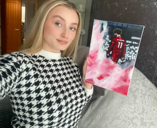 Artist Abigail Rudkin with one of her Mohammed Salah pieces
