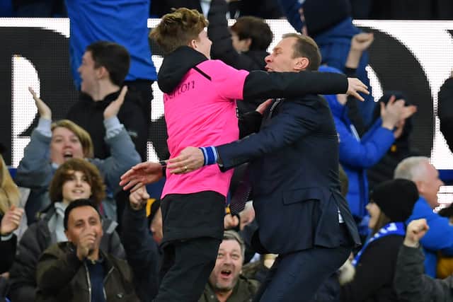 Duncan Ferguson celebrates with a ballboy during his first spell as Everton caretaker manager. Picture: PAUL ELLIS/AFP via Getty Images