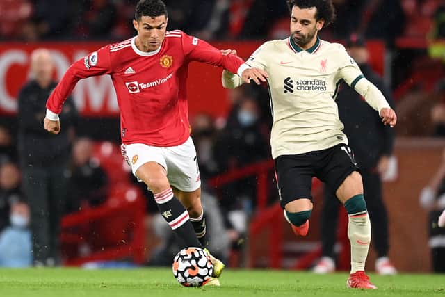 Mo Salah battles Cristiano Ronaldo for the ball during Liverpool’s 5-0 win at Man Utd earlier this season. Picture: Michael Regan/Getty Images