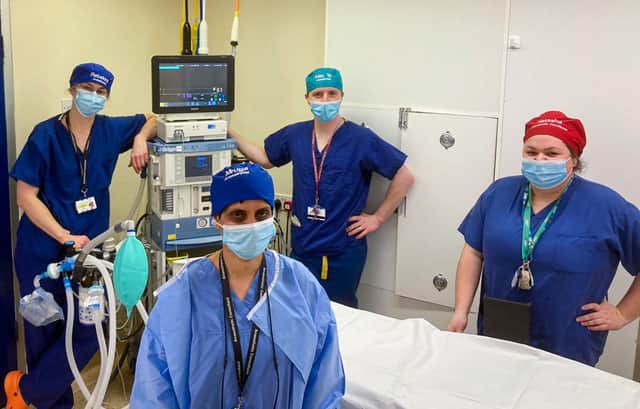 Dr Mruga Diwan, consultant anaesthetist at Liverpool University Hospitals, with colleagues in their named theatre caps. Image: LUHFT 
