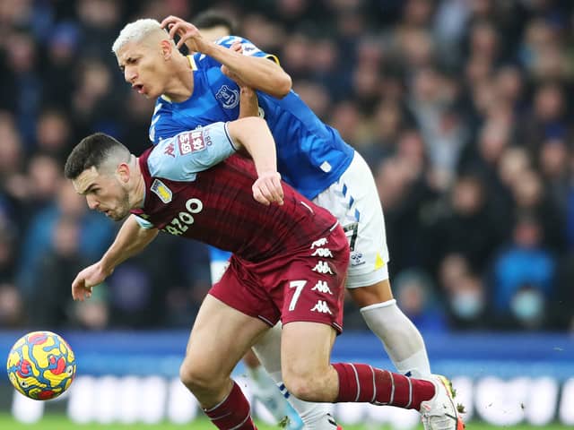 Richarlison of Everton battles for possession with JohnÂ McGinn of Aston Villa during the Premier League match between Everton and Aston Villa at Goodison Park on January 22, 2022 in Liverpool, England. (Photo by Jan Kruger/Getty Images)