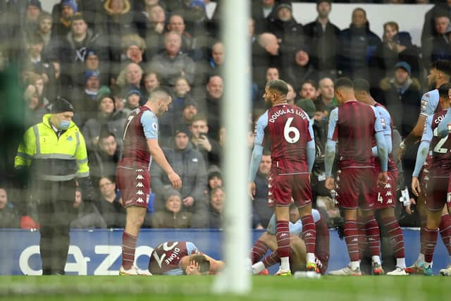  Lucas Digne of Aston Villa is hit by an object thrown from the crowd after celebrating their sides first goal during the Premier League match between Everton and Aston Villa at Goodison Park on January 22, 2022 in Liverpool, England. (Photo by Michael Regan/Getty Images