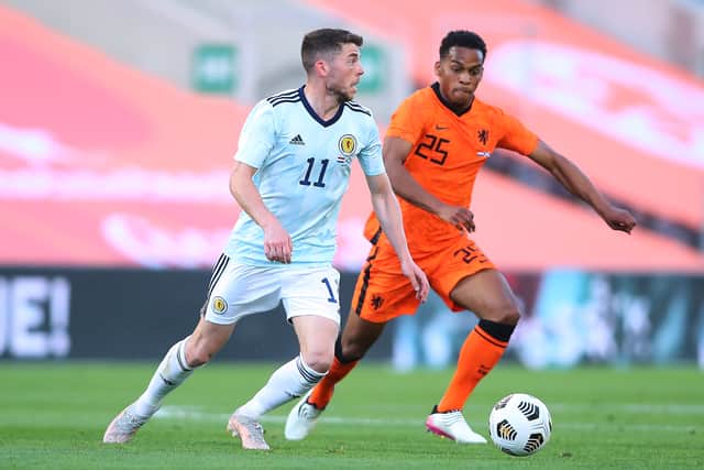 Cody Gakpo of Netherlands competes for the ball with Ryan Christie of Scotland during the international friendly match between Netherlands and Scotland at Estadio Algarve on June 02, 2021 in Faro, Portugal.