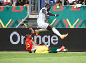 Issiaga Sylla (down) tackles Senegal’s forward Sadio Mane during the Group (Photo by PIUS UTOMI EKPEI/AFP via Getty Images)