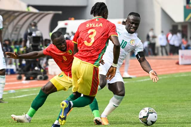 Guinea's defender Issiaga Sylla fight for the ball wtih Senegal's forward Sadio Mane (Photo by PIUS UTOMI EKPEI/AFP via Getty Images)