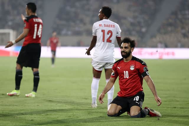 Egypt's forward Mohamed Salah (R) celebrates next to Sudan's midfielder Mustafa Ahmed Saeed (Photo by KENZO TRIBOUILLARD/AFP via Getty Images)