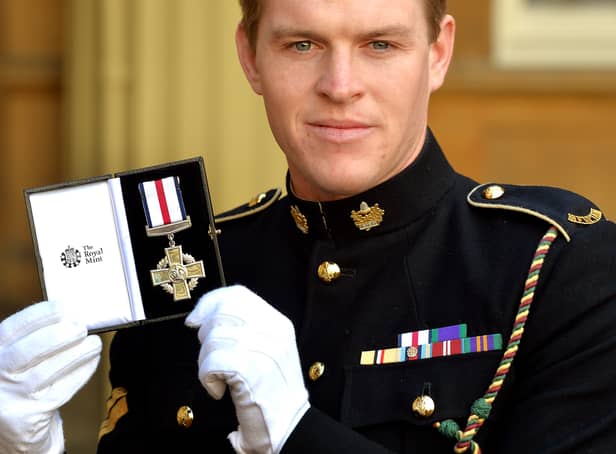 <p>Corporal Josh Griffiths of the Mercian Regiment holds his Conspicuous Gallantry Cross. Photo: John Stillwell - WPA Pool/Getty Images</p>