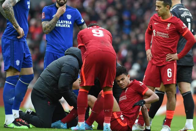 Luis Diaz receives treatment during Liverpool’s defeat of Cardiff. Picture: John Powell/Liverpool FC via Getty Images)